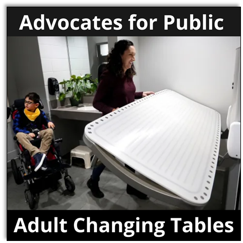 Advocates for public adult changing tables. Mother flips up an adult changing table while her son sits behind her in his wheelchair